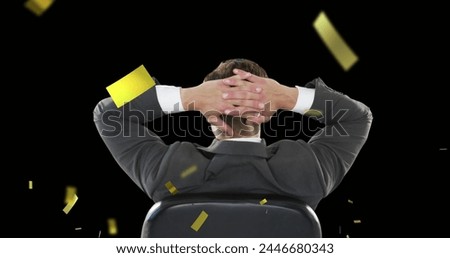 Digital composite of a Caucasian businessman in a suit sitting in a swivel chair raising both hands to the back of his head while gold confetti fall in the screen. 4k