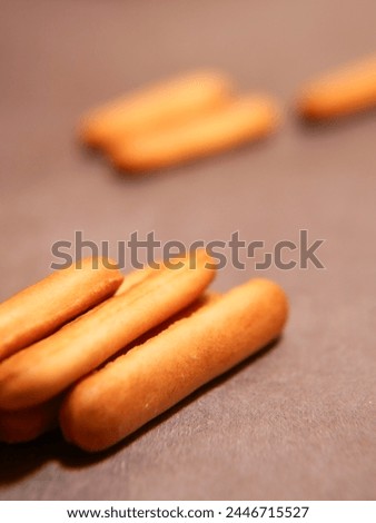 Material advertisement lettering finger biscuit Royalty-Free Stock Photo #2446715527