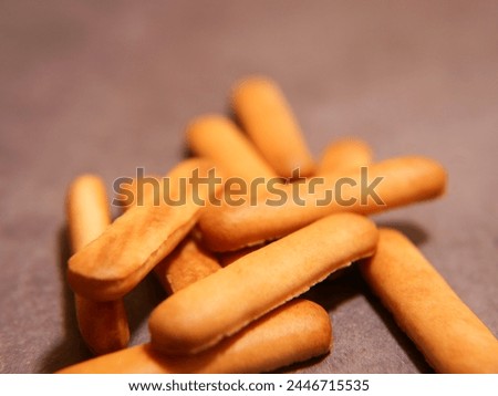 Material advertisement lettering finger biscuit Royalty-Free Stock Photo #2446715535