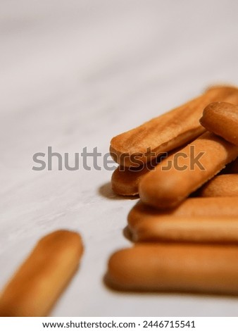 Material advertisement lettering finger biscuit Royalty-Free Stock Photo #2446715541