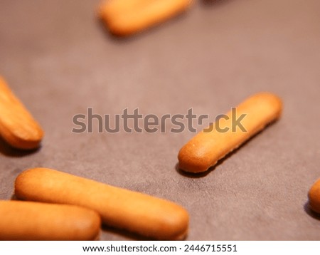 Material advertisement lettering finger biscuit Royalty-Free Stock Photo #2446715551