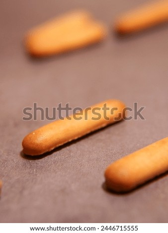 Material advertisement lettering finger biscuit Royalty-Free Stock Photo #2446715555