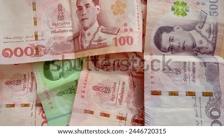 Close-up of a pile of twenty baht, fifty baht, one hundred, five hundred and one thousand Thai baht (THB) notes of Thailand. high-resolution background images. Royalty-Free Stock Photo #2446720315