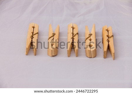 Wooden Clothespins Pegs for laundry uses Front Side and top View Close up Isolated on White Background, shot is selective focus with shallow depth of field, taken at Cairo Egypt Royalty-Free Stock Photo #2446722295