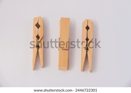 Wooden Clothespins Pegs for laundry uses Front Side and top View Close up Isolated on White Background, shot is selective focus with shallow depth of field, taken at Cairo Egypt Royalty-Free Stock Photo #2446722301
