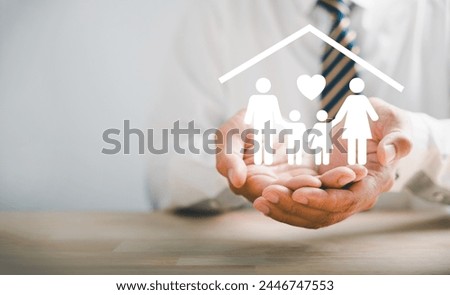 Symbolizing family protection and insurance. Businessman with protective gesture and family silhouette. Icons for family, life, health, and house insurance. Signifying insurance concept.
