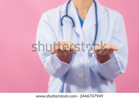 Palm up, Close up female medical doctor isolated on pink background.