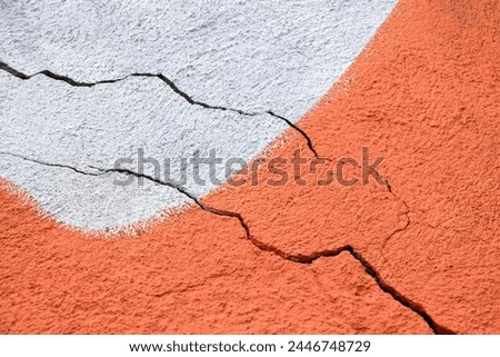 Two big winding descending crack on old multicolored plastering wall. Copy space. Selective focus. Royalty-Free Stock Photo #2446748729