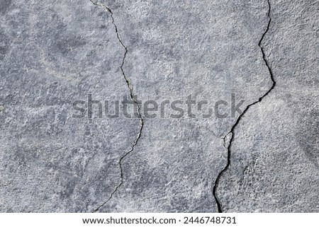 The wall of an old building with many winding, deep cracks. Copy space. Selective focus. Royalty-Free Stock Photo #2446748731