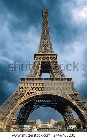 The Eiffel Tower in Paris, France against a thunderstorm background.

