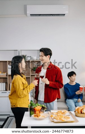 Group of Young Asian friend having, enjoy evening party together at home. Attractive young man and woman having fun, eating food, celebrate at modern home