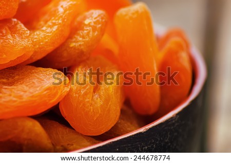 dried apricots on a dark wood background. tinting. selective focus