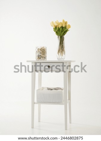 yellow tulips standing on a stan. Flowers still life. Minimalistic picture