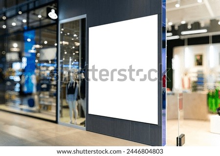 Mockup Blank billboard on the wall near entrance door of casual clothes shop, Empty space for insert media advertisement, discount, special price and promotion at front of clothes showroom