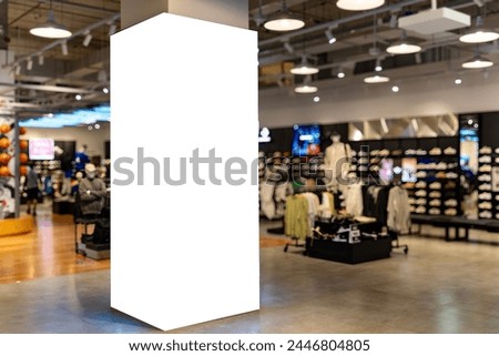 Mockup Blank tall light box billboard Four sides around pole in clothes shop at shopping mall, Empty space for insert media advertisement, discount, special price and promotion of clothes showroom