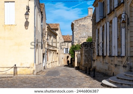 Views of old houses and narrow hilly streets of medieval town St. Emilion, production of red Bordeaux wine on cru class vineyards in Saint-Emilion wine making region, France, Bordeaux Royalty-Free Stock Photo #2446806387