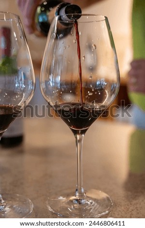Tasting of red dry Saint-Emilion wine aged in French oak wooden barrels in cellar, Saint-Emilion great wines making region, France, Bordeaux made from Merlot, Cabernet Sauvignon red wine grapes Royalty-Free Stock Photo #2446806411