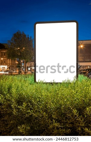 Blank Mockup Of Billboard At Night. Advertising Screen Stand In A Bush