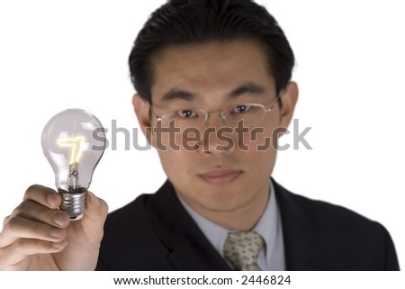 A chinese business man holding a light bulb.