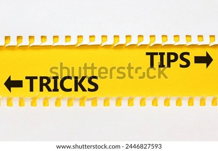 Tips and tricks symbol. Concept word Tips and tricks on beautiful yellow paper. Beautiful white paper background. Business and Tips and tricks concept. Copy space.