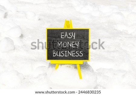 Easy money business symbol. Concept words Easy money business on beautiful black chalk blackboard. Beautiful white snow background. Easy money business concept. Copy space.