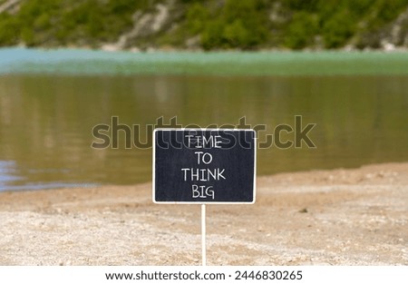 Time to think big symbol. Concept words Time to think big on beautiful black chalk blackboard. Beautiful mountain lake background. Business and time to think big concept. Copy space.