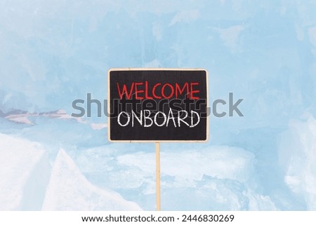 Welcome onboard symbol. Concept words Welcome onboard on beautiful yellow black blackboard. Beautiful blue ice background. Business, motivational welcome onboard concept. Copy space.