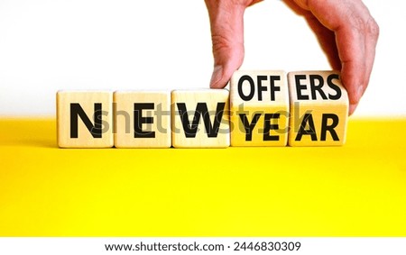 New year and offers symbol. Concept word New year New offers on beautiful wooden cubes. Beautiful yellow table white background. Businessman hand. Business new year and offers concept. Copy space.
