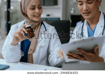 Doctor and nurse examining patient's medical records and medical team working.