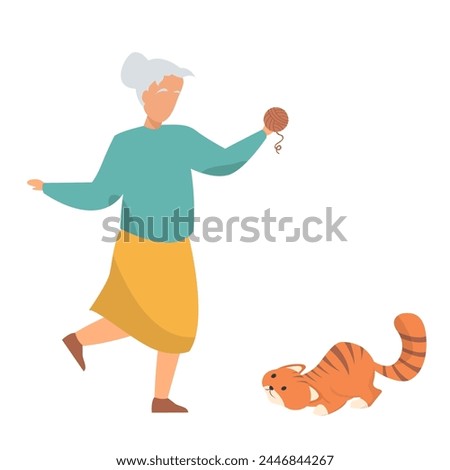 old lady playing with her ginger cat using a yarn ball