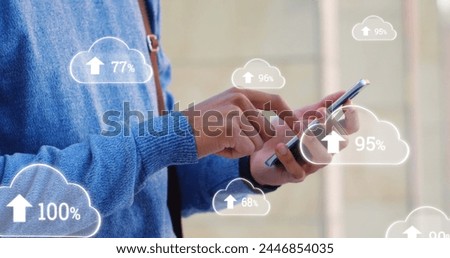 Digital composite of man in blue sweater using his mobile phone. Digital image of uploading grey digital clouds as foreground 4k