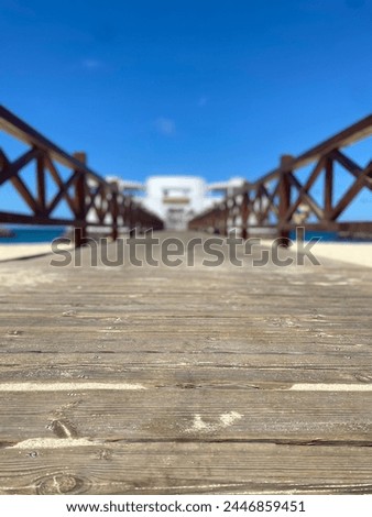 Cape Verde sea front sunny blue sky slight clouds decking leading to building Royalty-Free Stock Photo #2446859451