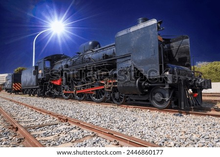 At night, the old steam locomotive is illuminated by modern street lights, forming an interesting picture with historical significance.  Hamason Railway Cultural Park, Kaohsiung City, Taiwan