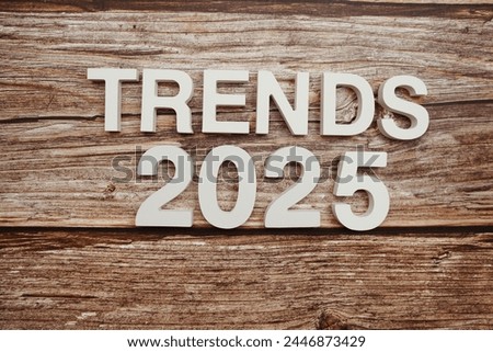 Trends 2025 alphabet letters on wooden background