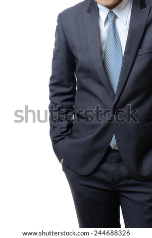 businessman in a suit holds hands in pockets isolated on white background