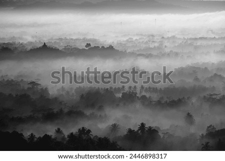 Borobudur Temple, Java, Indonesia. Morning, sunrise in the low cloud. Black and White. 
