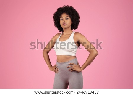 Confident African American woman with hands on hips in sportswear Royalty-Free Stock Photo #2446919439