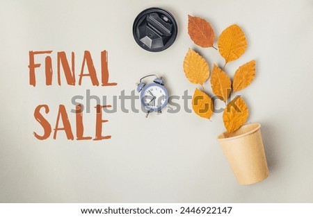 A close up of a clock and a cup with leaves on top of it. The words Final Sale are written below the clock and cup