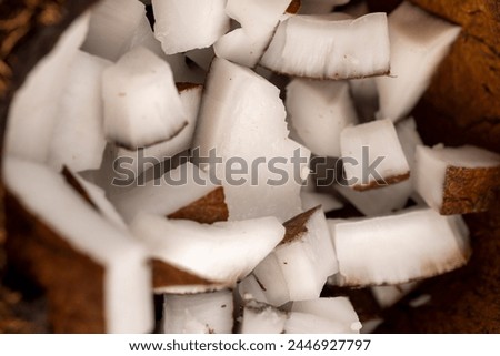 white coconut pulp and dried coconut flakes, a close-up of which is used in the preparation of desserts Royalty-Free Stock Photo #2446927797