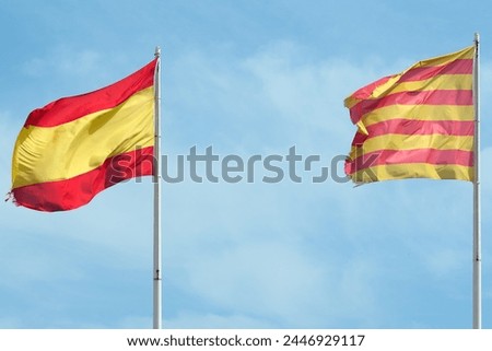 The image shows the flags of Catalonia and Spain waving together in a clear sky, symbolizing coexistence and mutual respect between both identities.