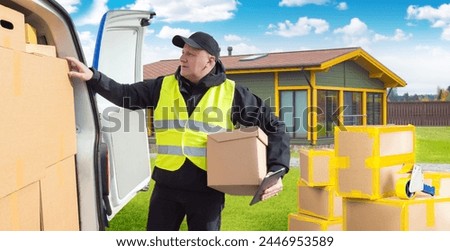 Man provides assistance for move. Worker is busy carrying boxes. Relocation process. Man with cardboxes near minivan. Carrying things when changing place of residence. Relocation, removal Royalty-Free Stock Photo #2446953589