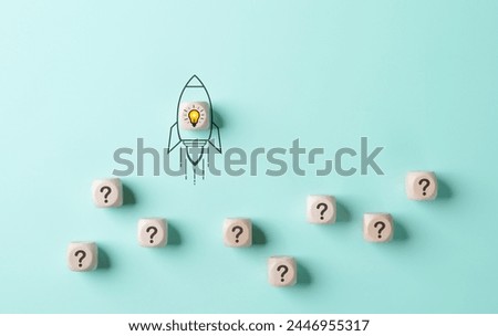 Problem solving and startup launch concept. A conceptual image of a rocket with a lightbulb taking off, surrounded by cubes with question marks on a light blue background. inspiration and innovation,