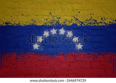 colorful painted big national flag of venezuela on a massive old brick wall