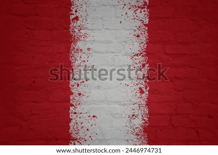 colorful painted big national flag of peru on a massive old brick wall