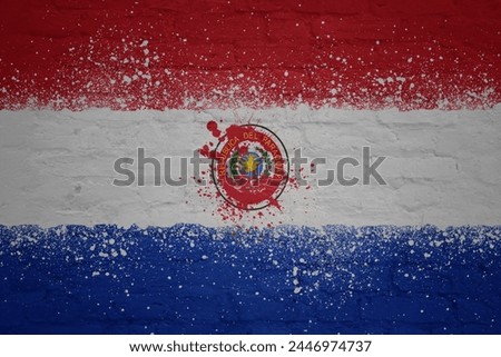 colorful painted big national flag of paraguay on a massive old brick wall