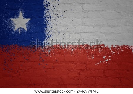 colorful painted big national flag of chile on a massive old brick wall