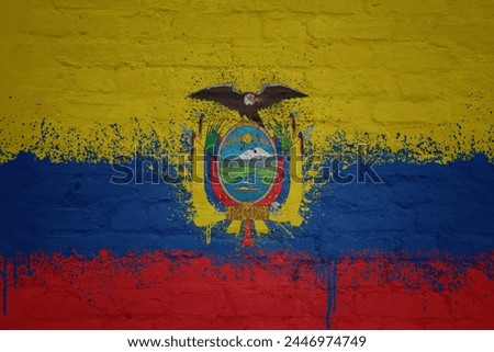 colorful painted big national flag of ecuador on a massive old brick wall