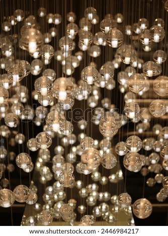Interior photo view of multiple garlands of bright glowing light bulbs luminous shiny shining in a room as a decoration decor for a resuarant or bar or public place