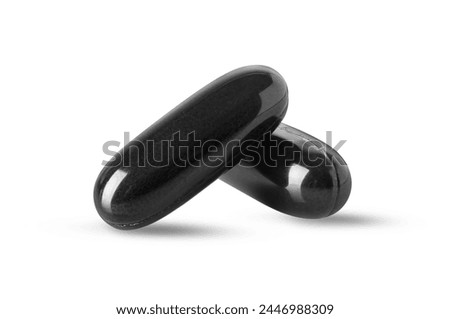 Black supplement soft gel for immunity support and health on white background. Royalty-Free Stock Photo #2446988309