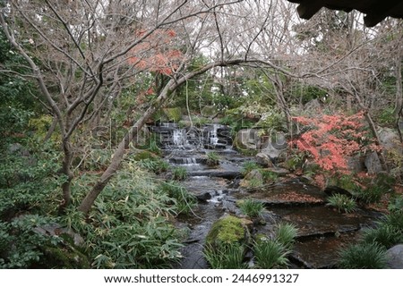 Waterfall in a Japanese garden in the end of autumn.